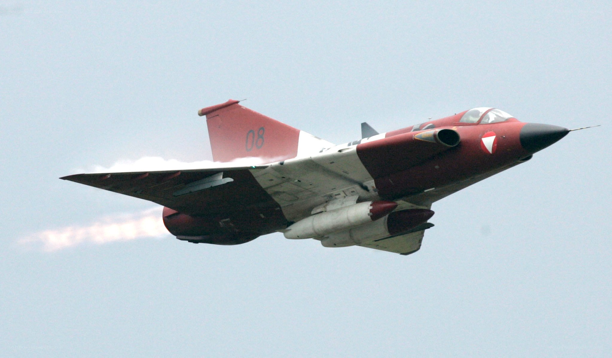 Red and white jet in flight