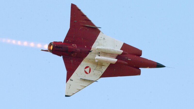 Red and white jet in flight