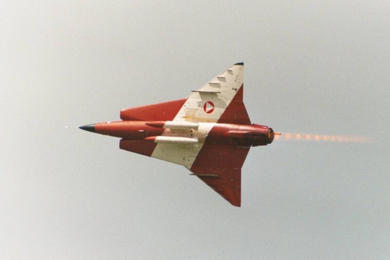 Red and white jet in flight