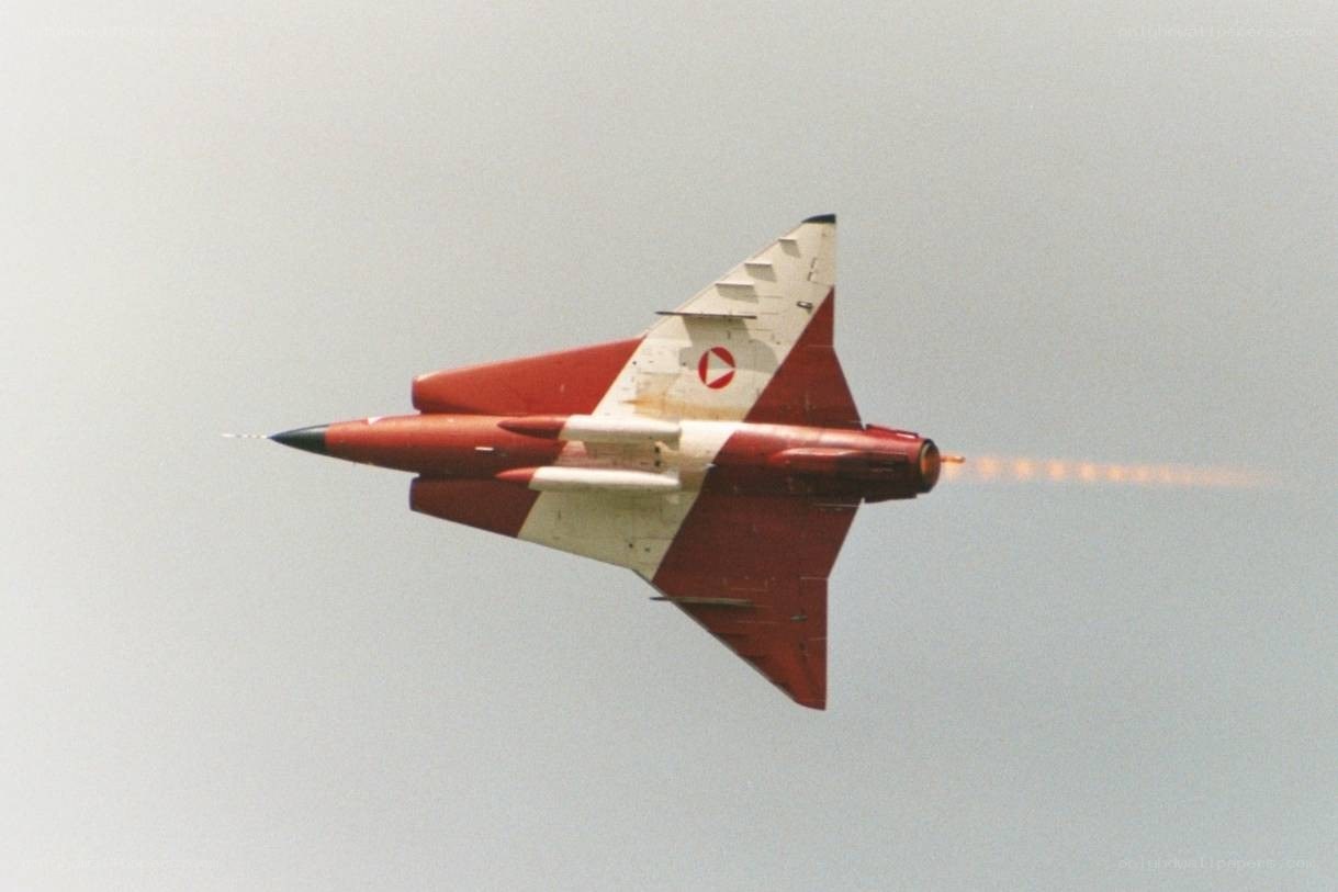 Red and white jet in flight
