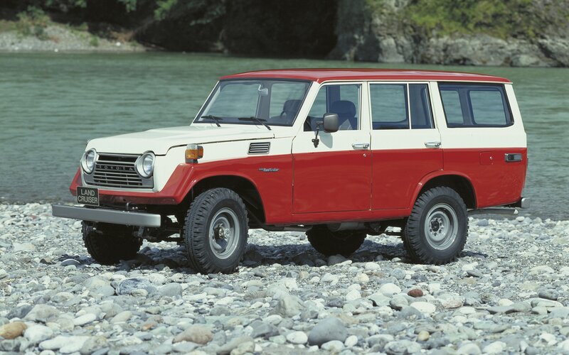 Red and white Land Cruiser by river
