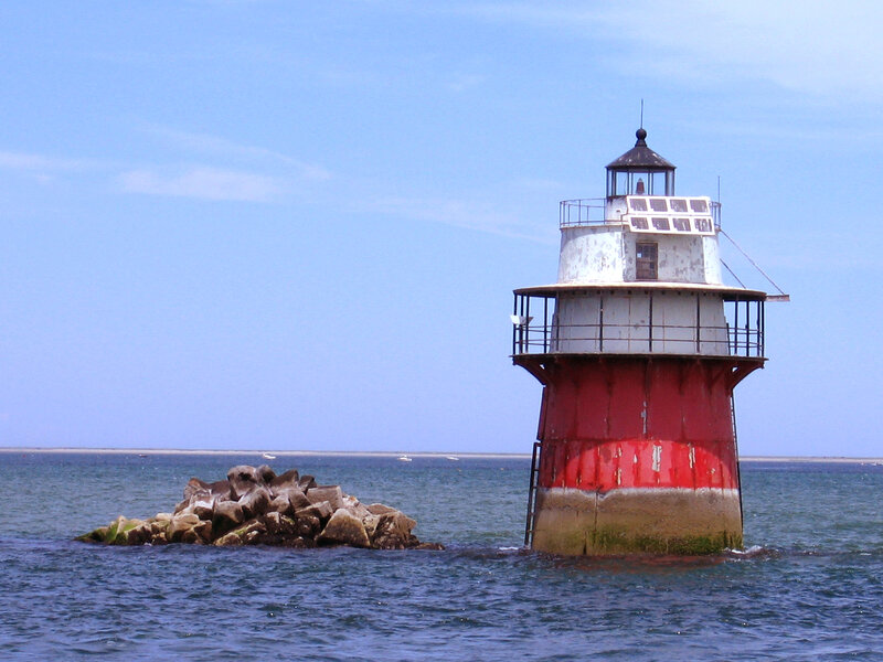 Red and white lighthouse in the sea