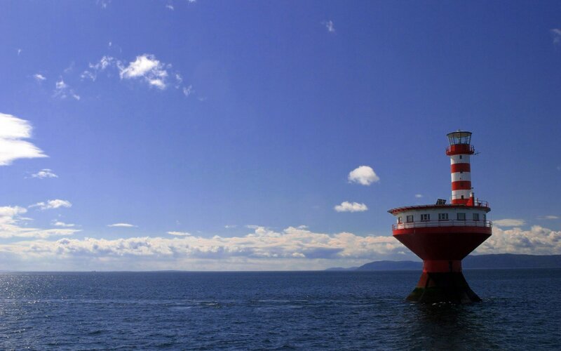 Red and white lighthouse in the sea