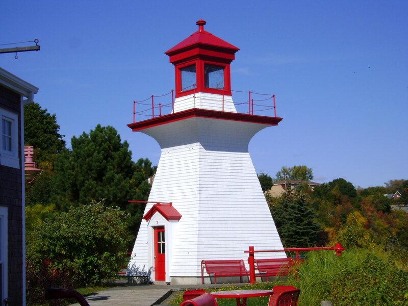 Red and white lighthouse on a sunny day