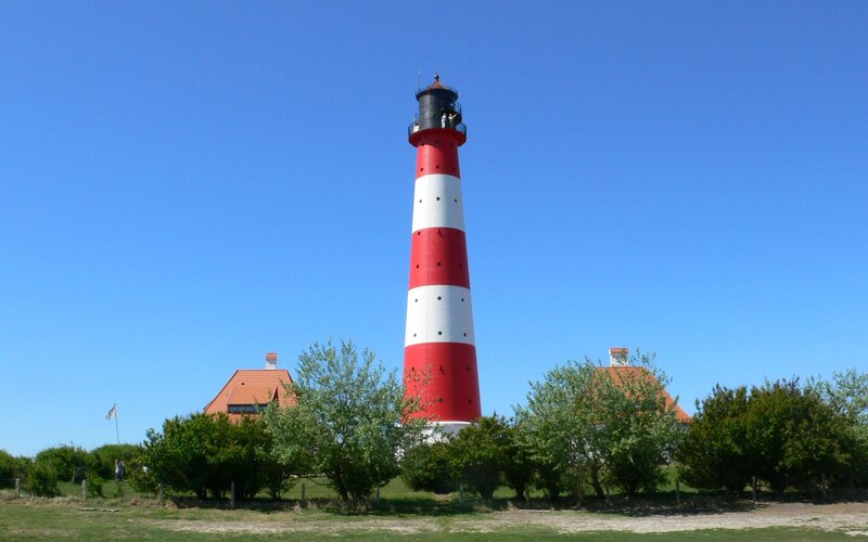 Red and white lighthouse on a sunny day