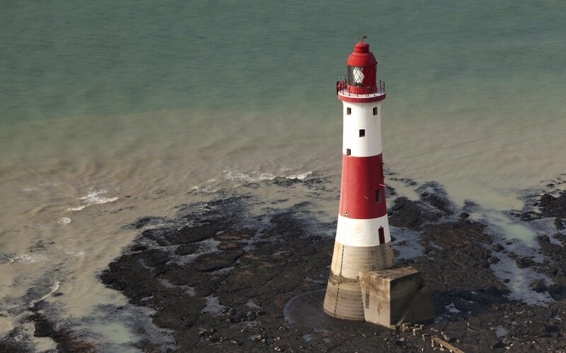 Red and White Lighthouse — Serene, Afternoon, Photograph, Ocean