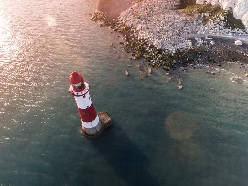 Red and White Lighthouse — Serene, Sunset