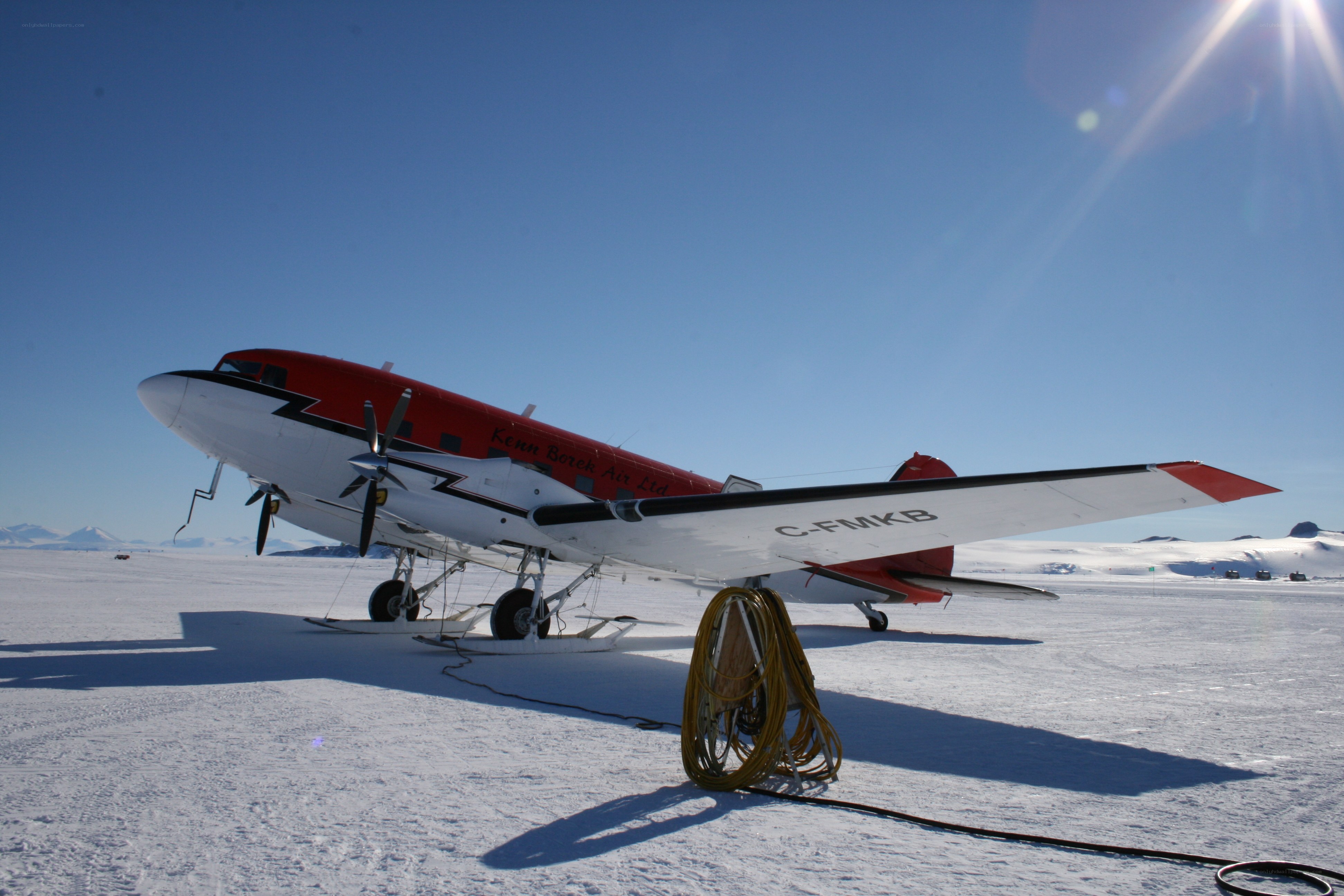 Red and white plane on snow