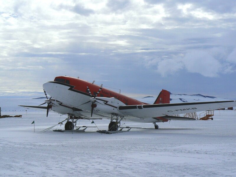 Red and white plane on snow