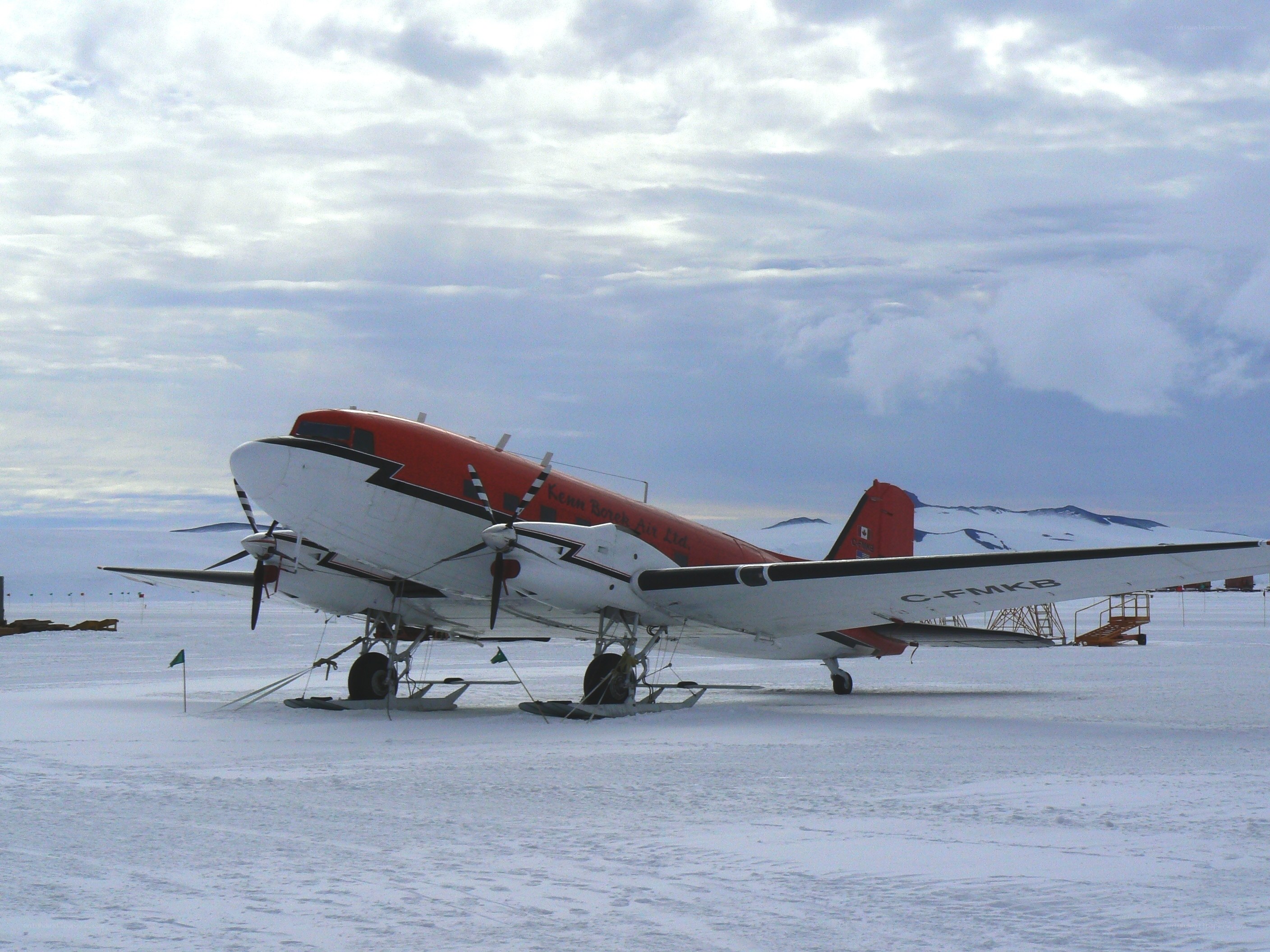 Red and white plane on snow