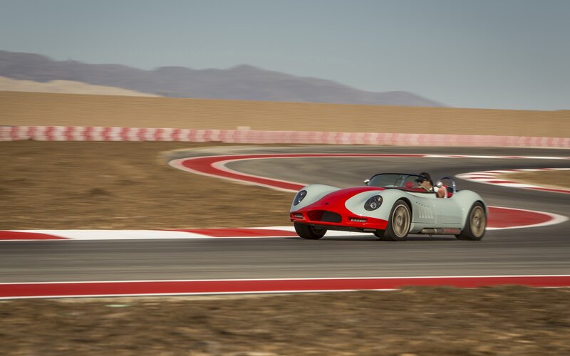 Red and white race car on track