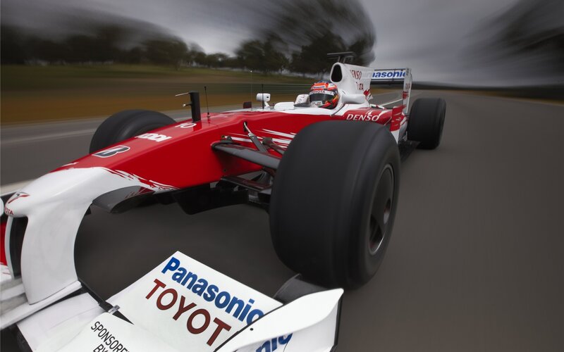 Red and white race car on track