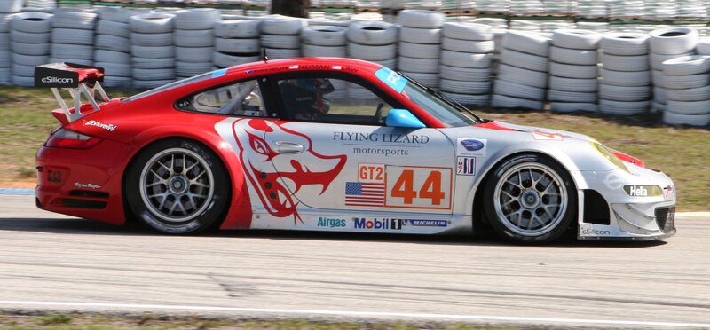 Red and white race car on track