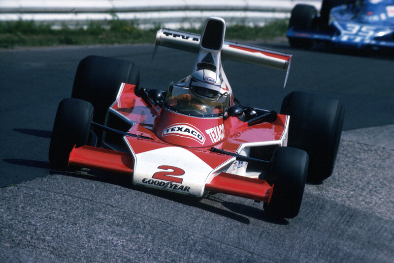Red and white race car on track