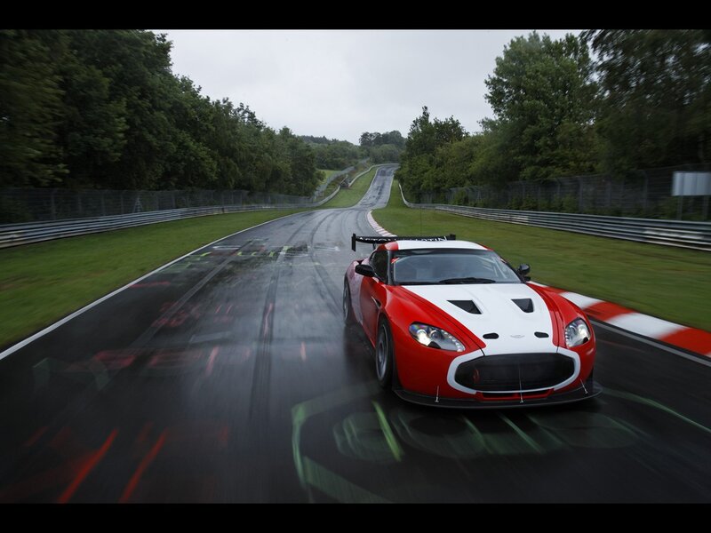 Red and white race car on wet track