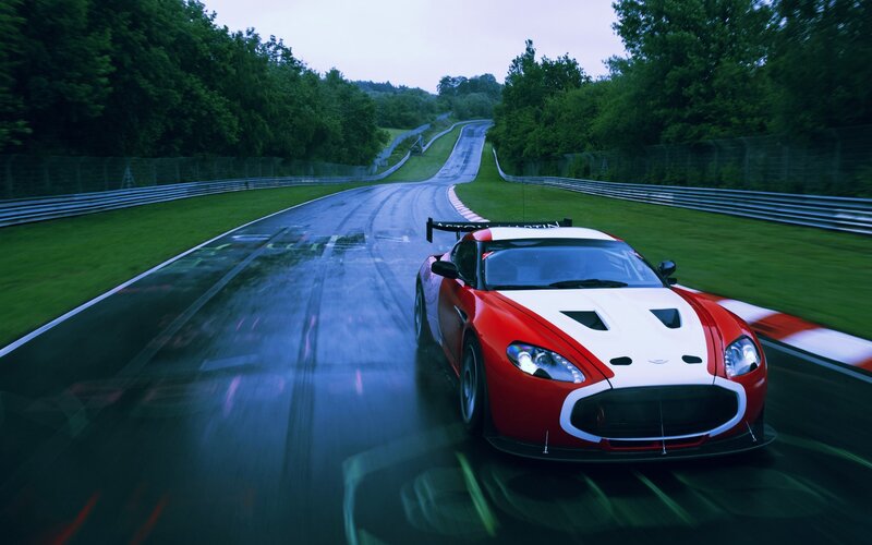Red and white race car on wet track