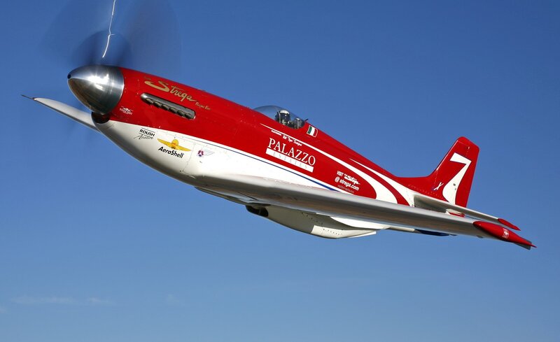 Red and white racing plane in flight