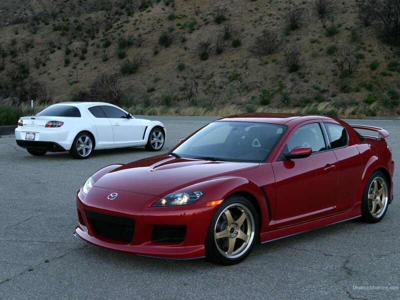 Red and white sports cars on road