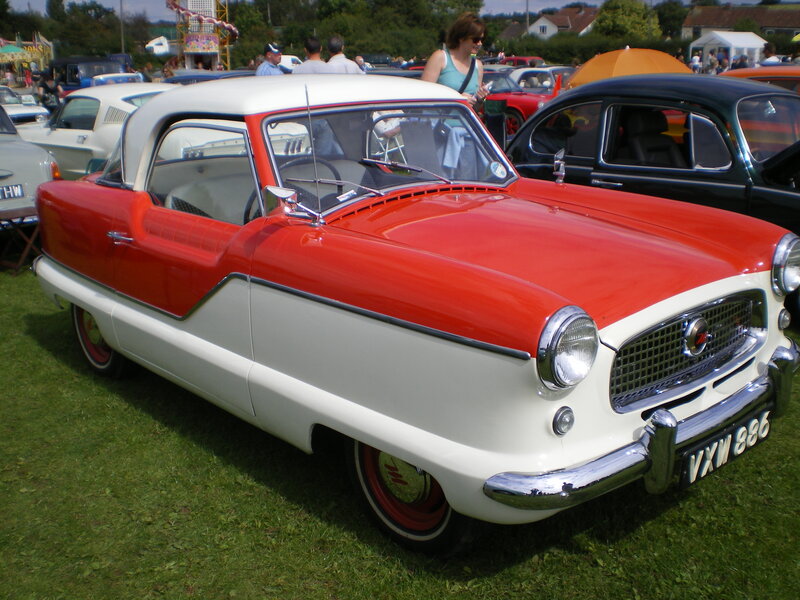 Red and white vintage car at a show