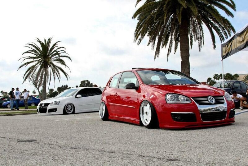 Red and white VW cars at a show