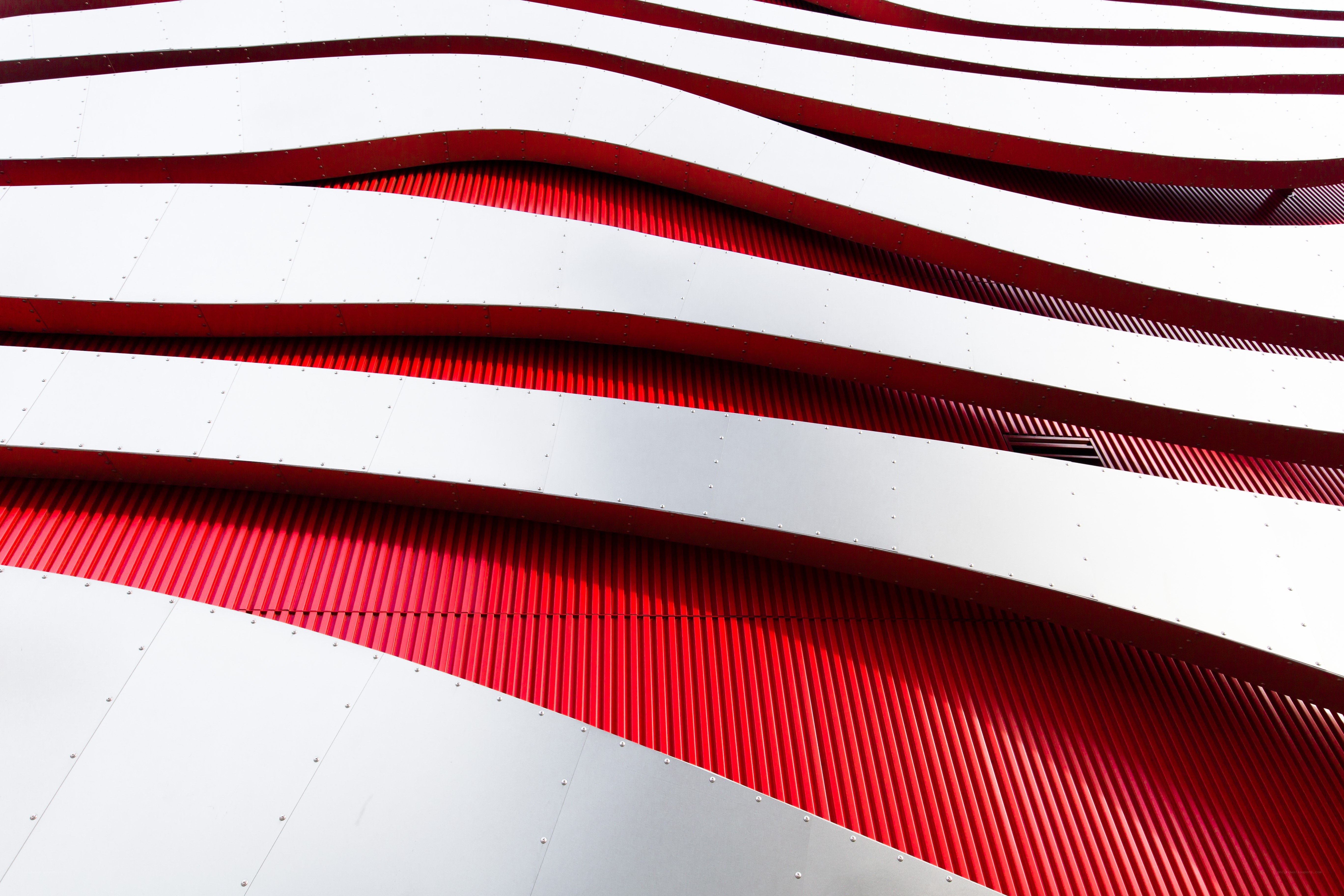Red and white wavy architectural panels