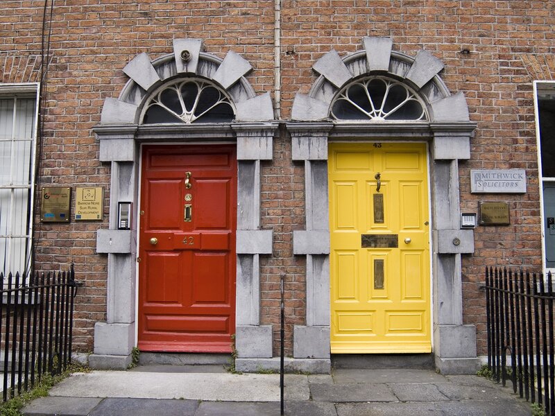 Red and yellow doors on brick building