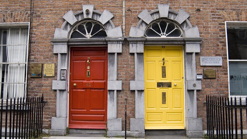 Red and yellow doors on brick building