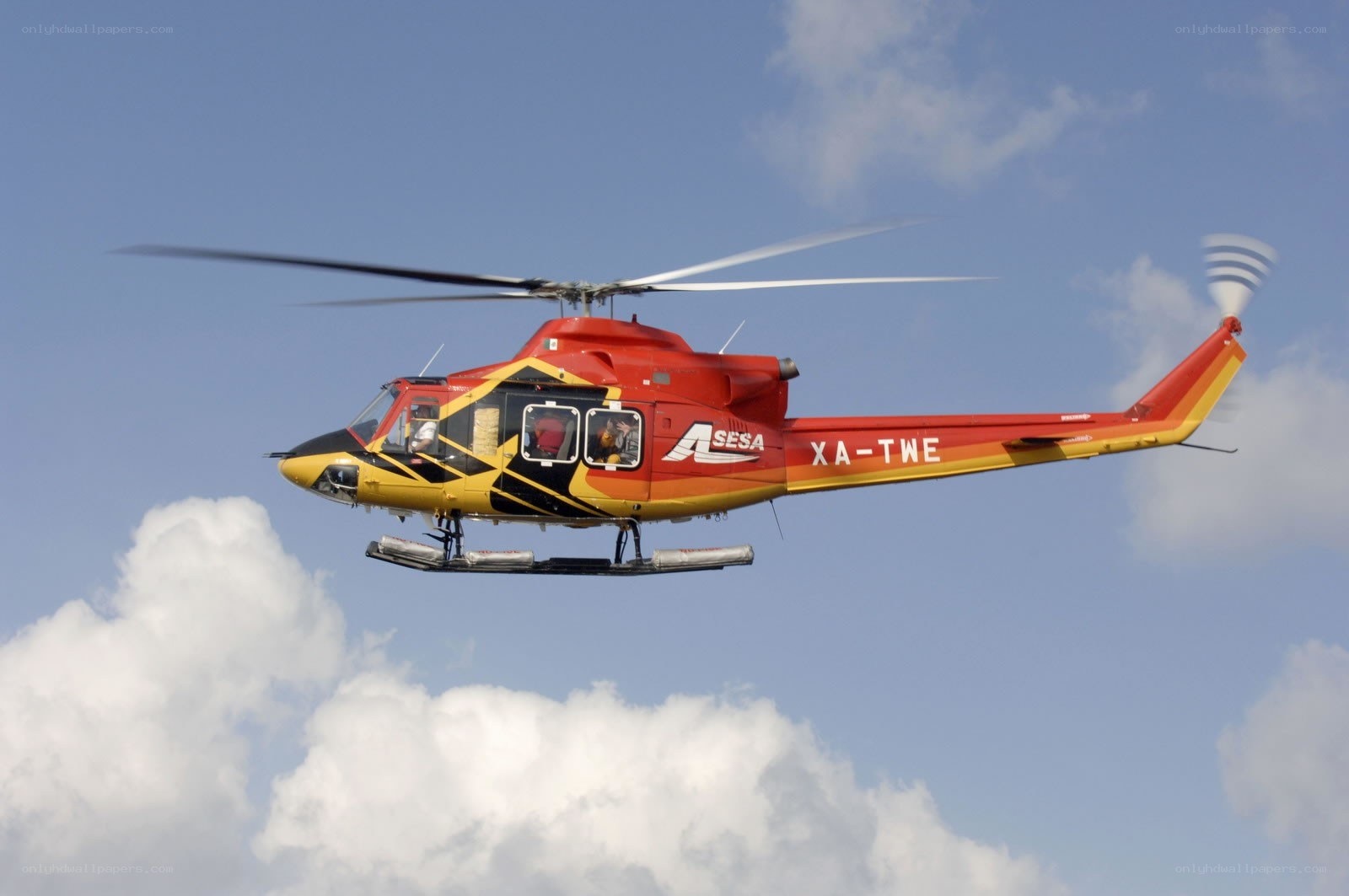 Red and yellow helicopter in flight