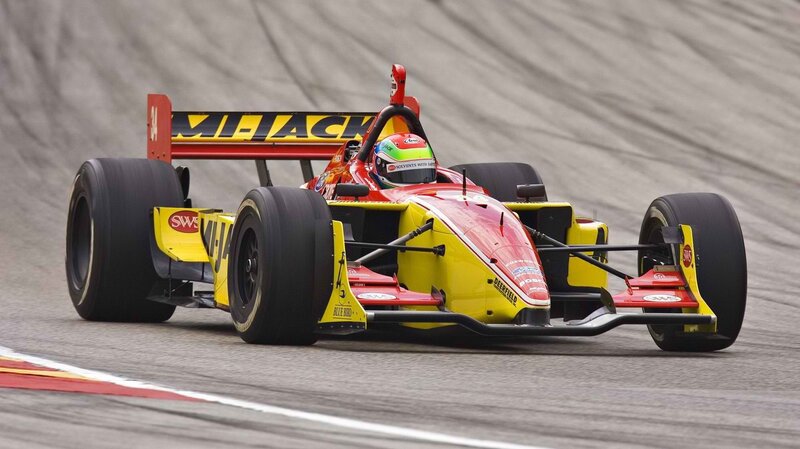 red and yellow race car on track