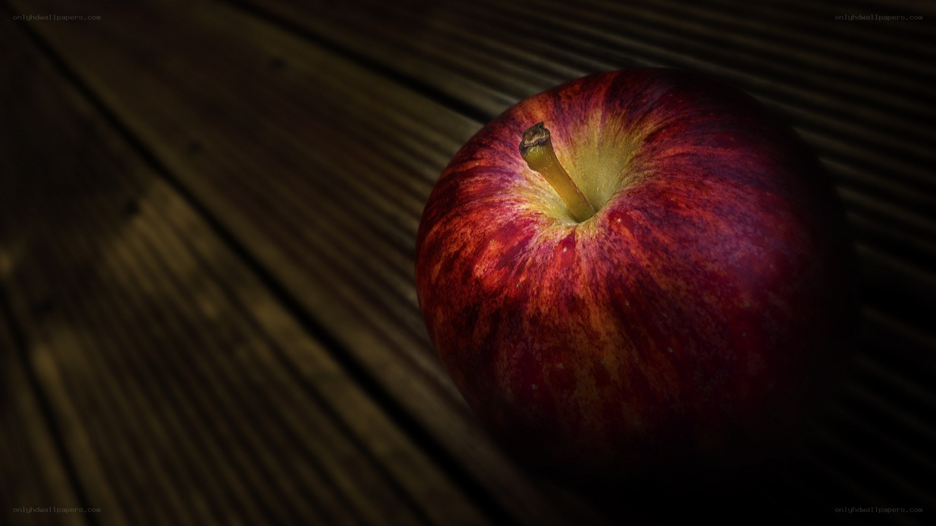 red apple on wooden surface