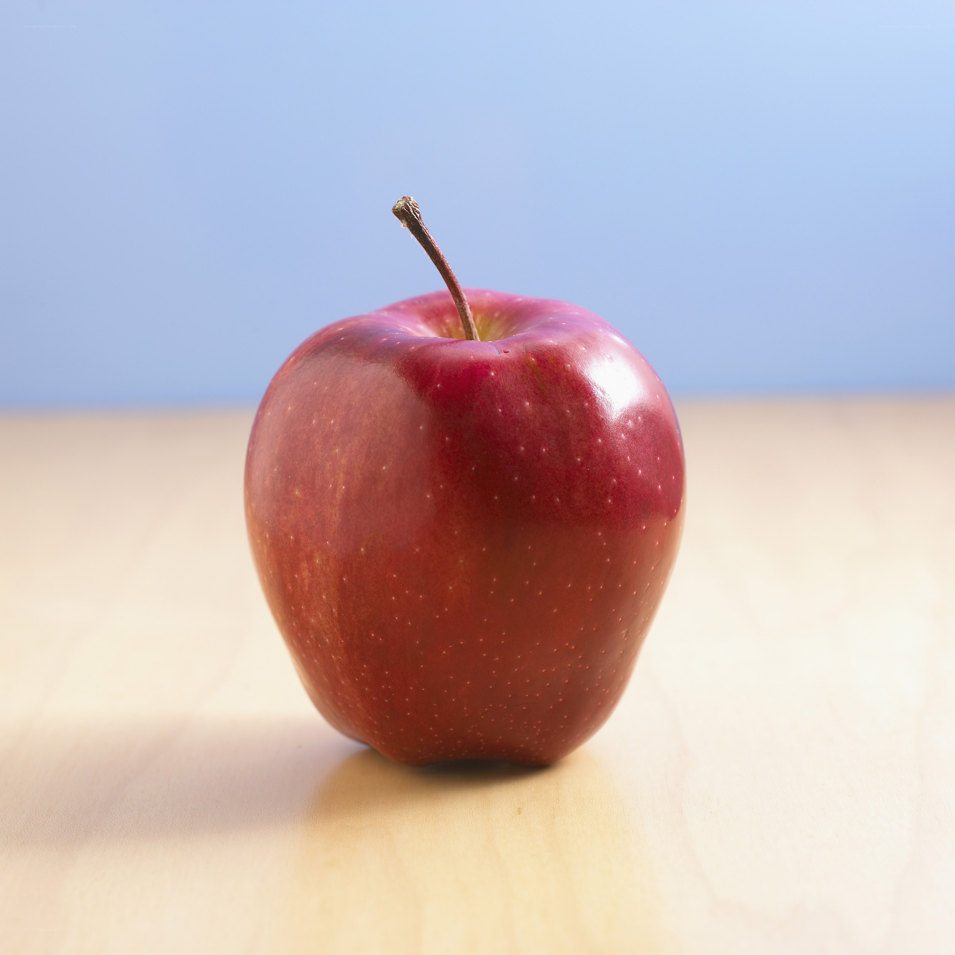 red apple on wooden surface