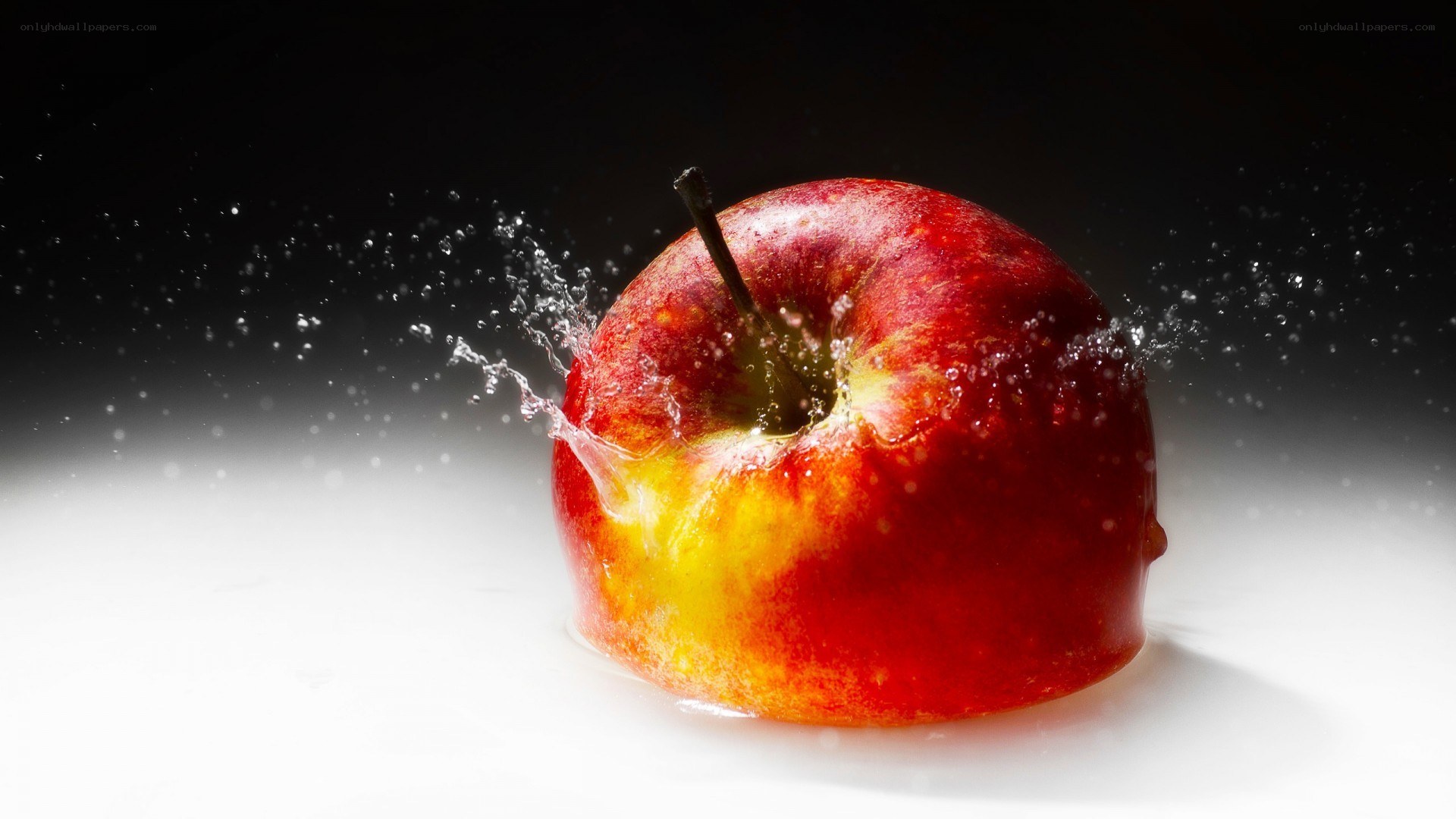 red apple splashing in water
