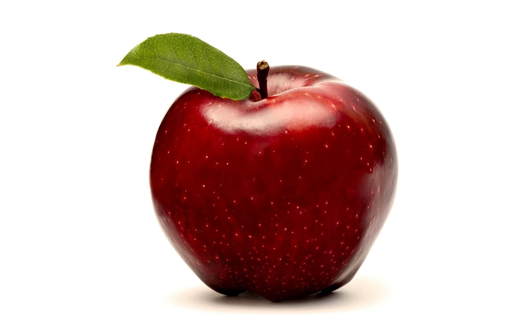 red apple with green leaf