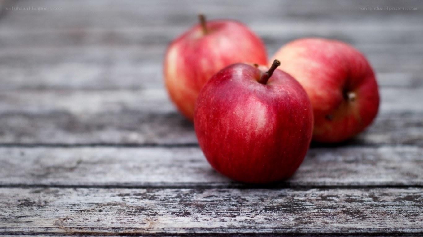 red apples on wooden surface