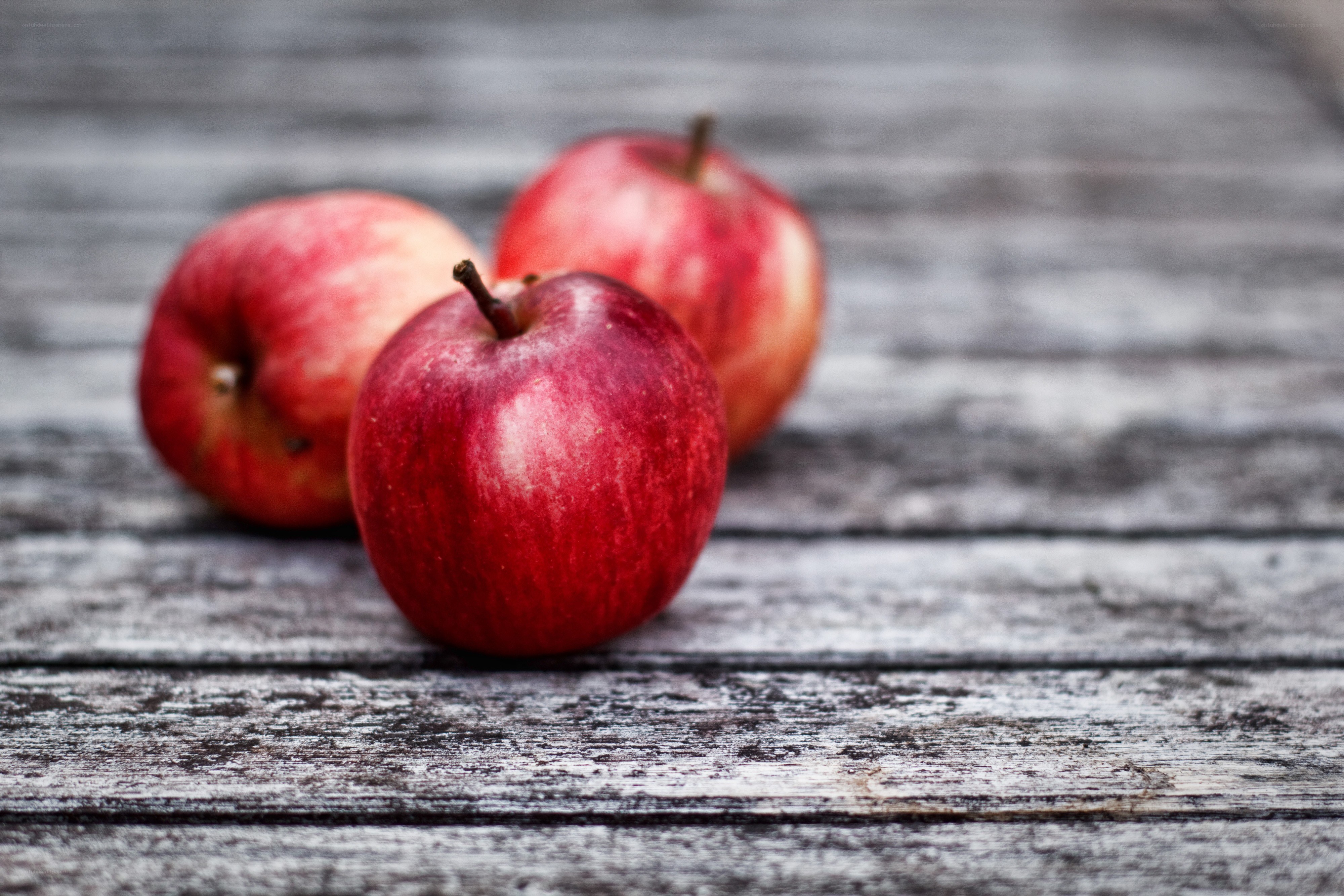 red apples on wooden surface