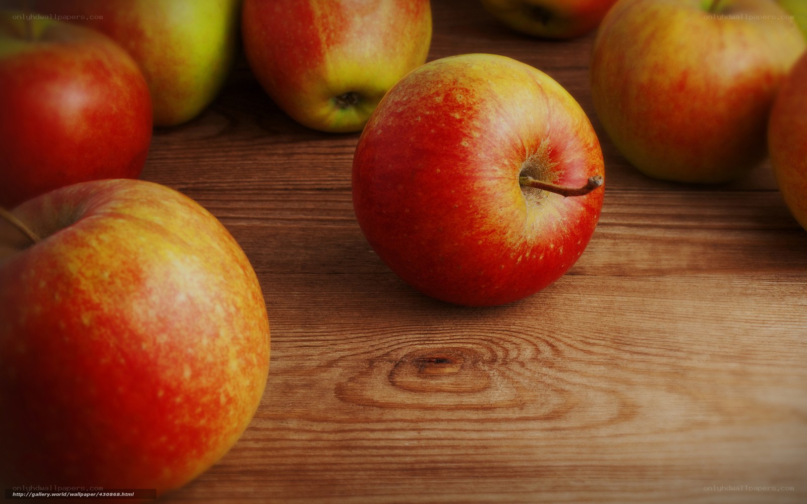 Red apples on wooden table