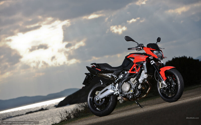 Red Aprilia motorcycle on coastal road