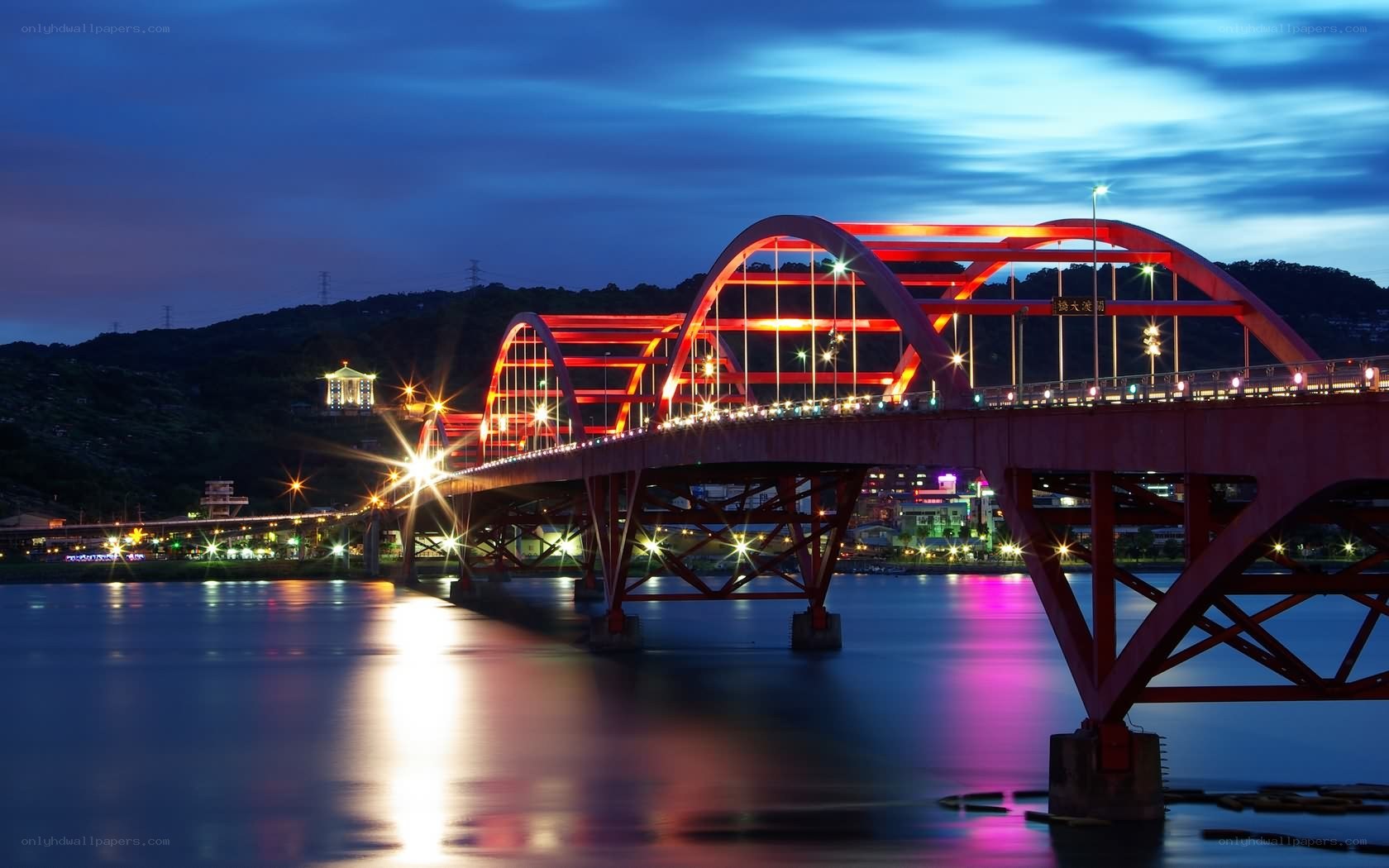 Red arch bridge at dusk