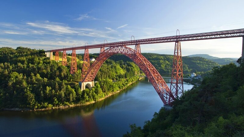 Red arch bridge over river