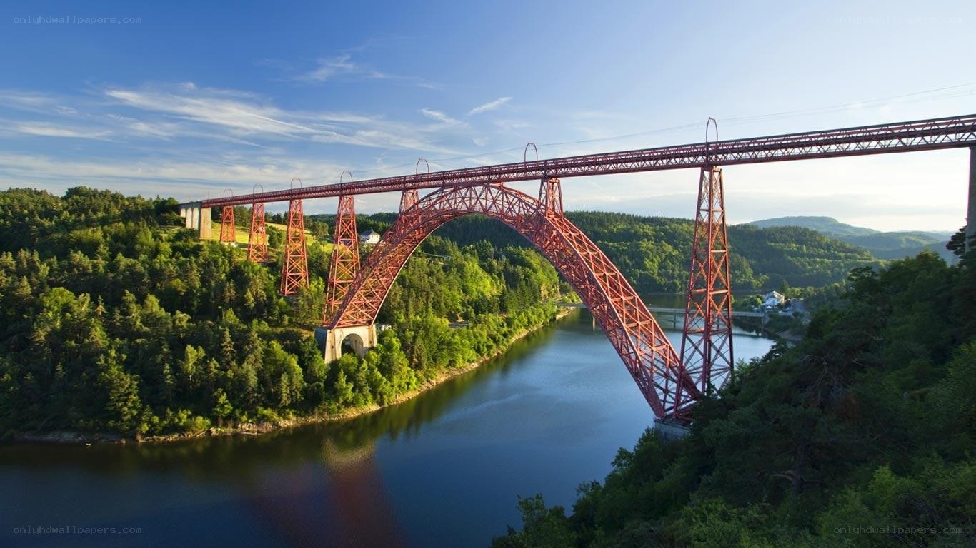 Red arch bridge over river