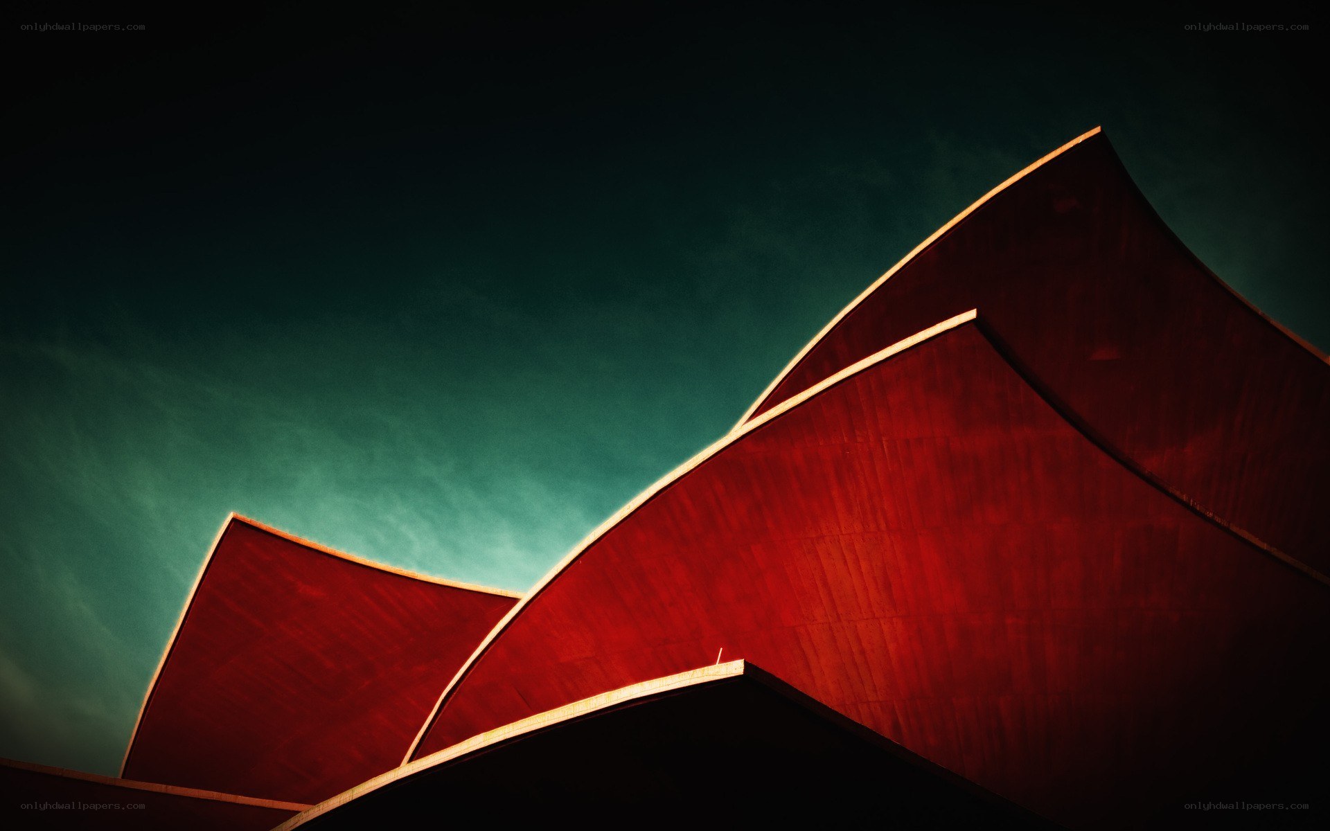 Red architectural forms against teal sky