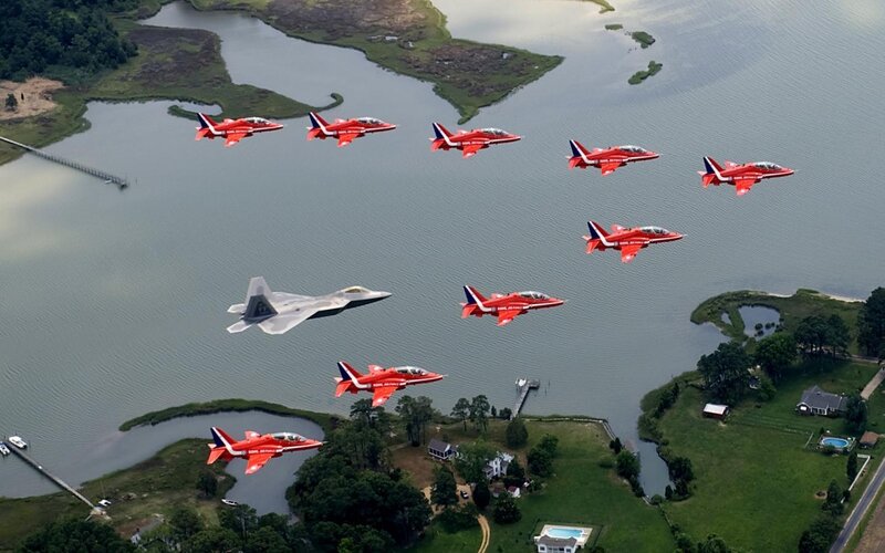 Red Arrows formation over water