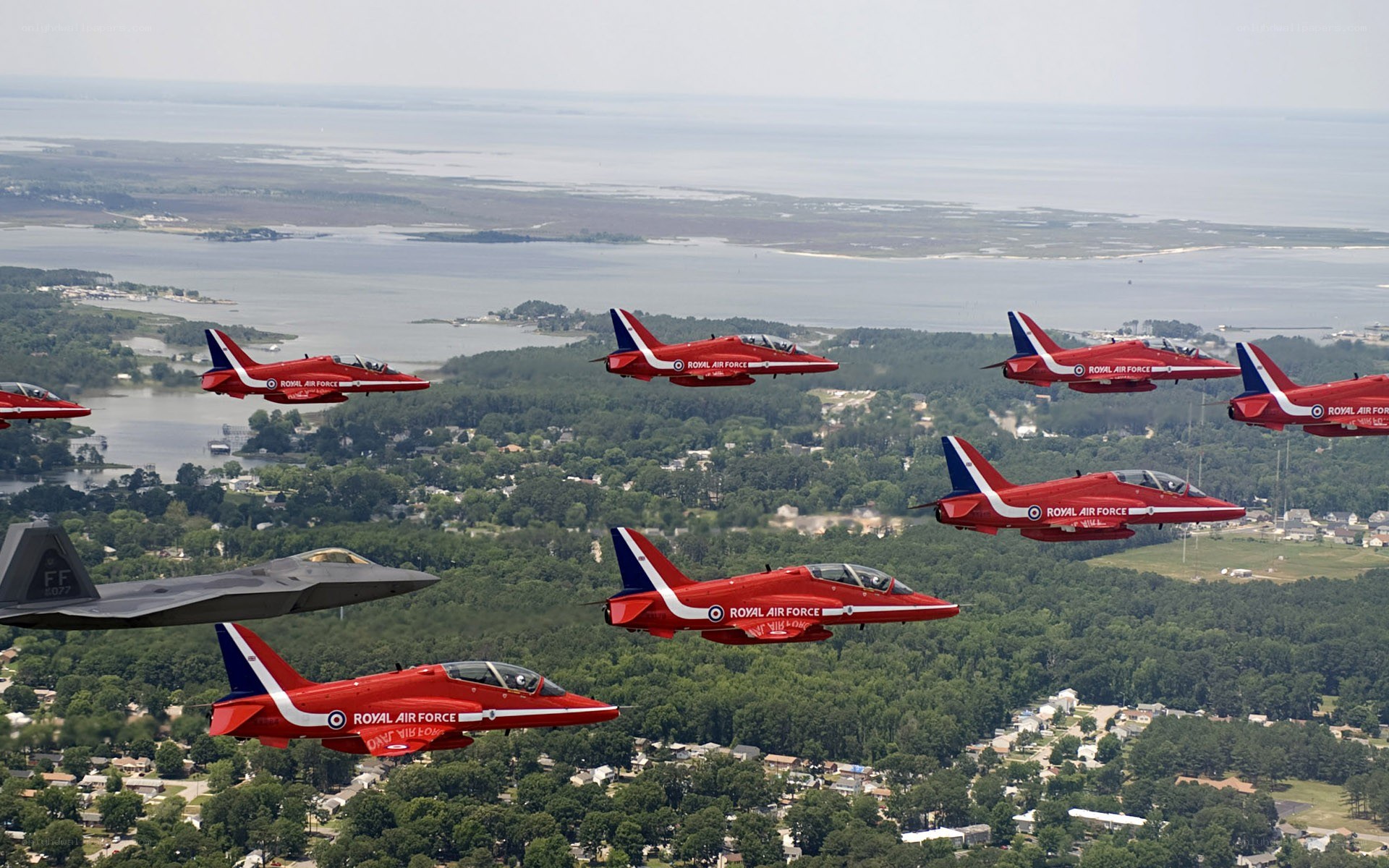 Red Arrows in formation over coastal town