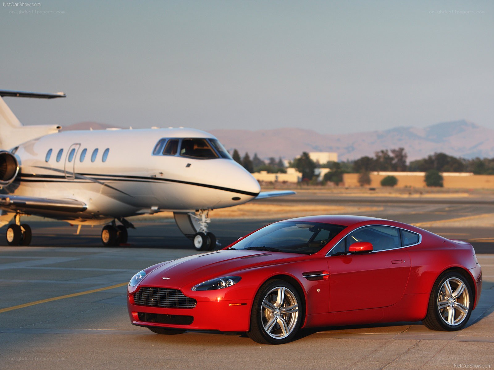Red Aston Martin and private jet