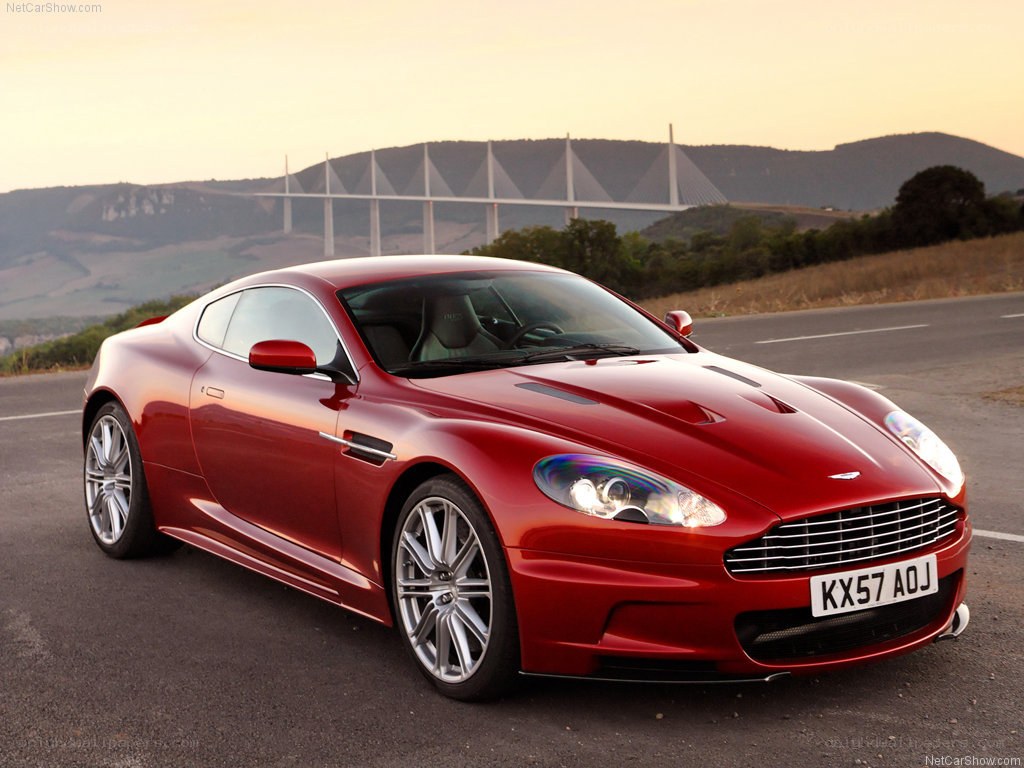 Red Aston Martin DBS on road