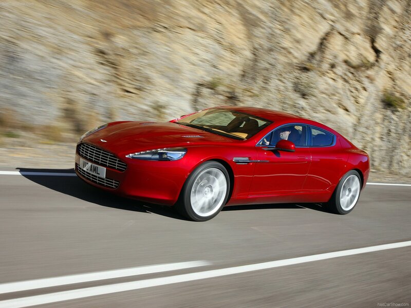 red aston martin driving on road