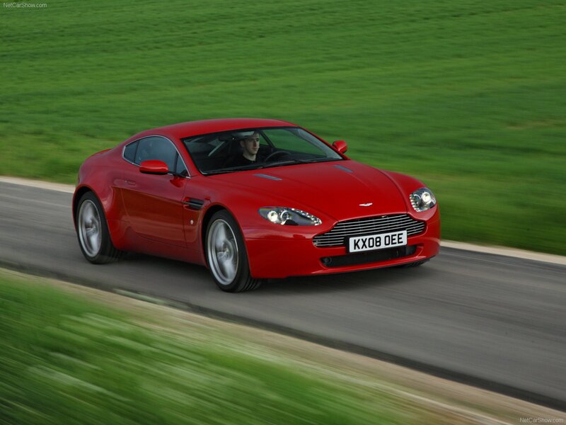 red aston martin driving on road