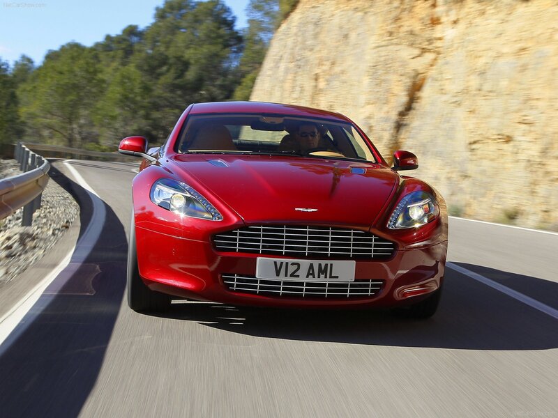 red aston martin driving on road