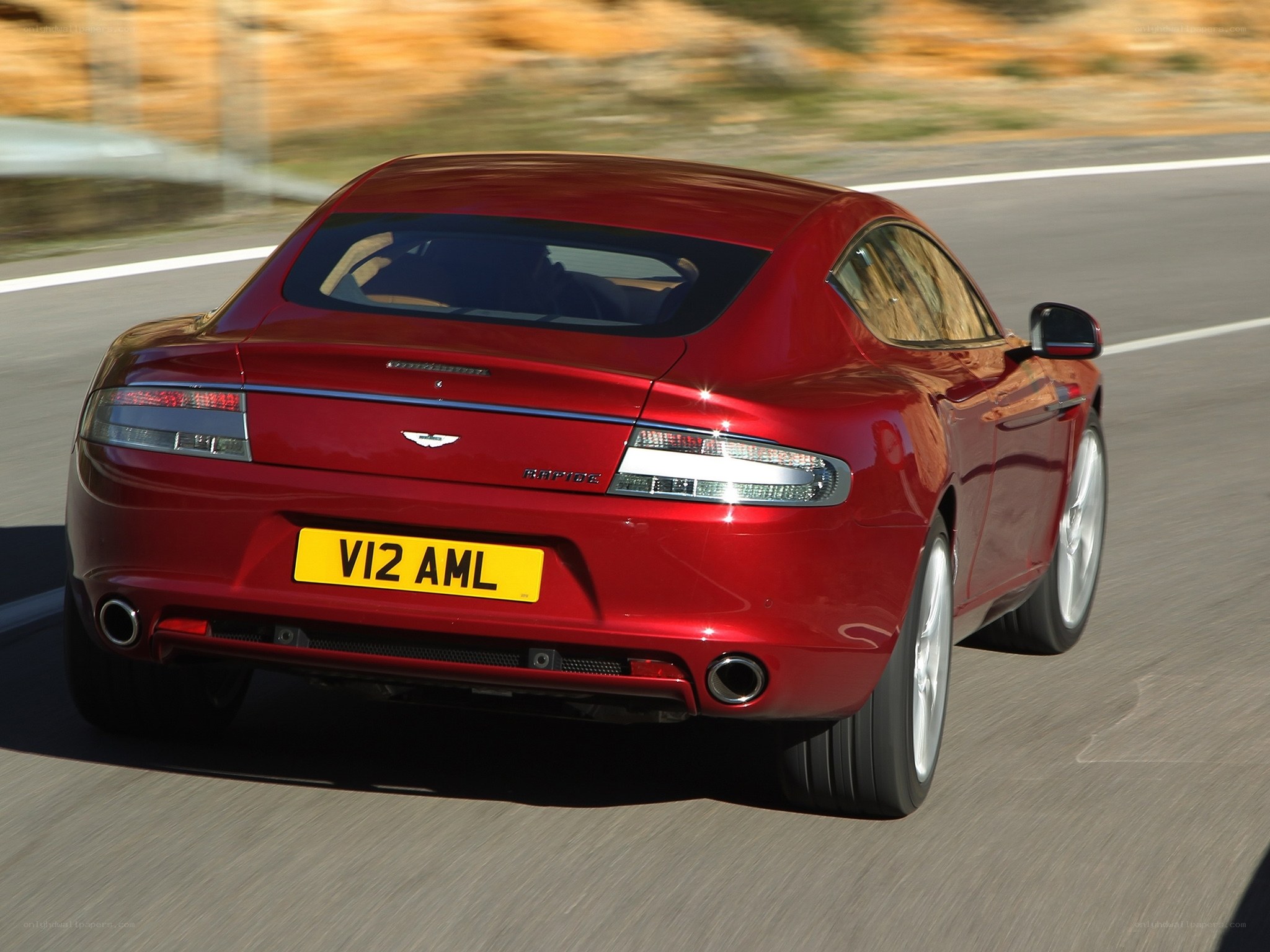 red aston martin driving