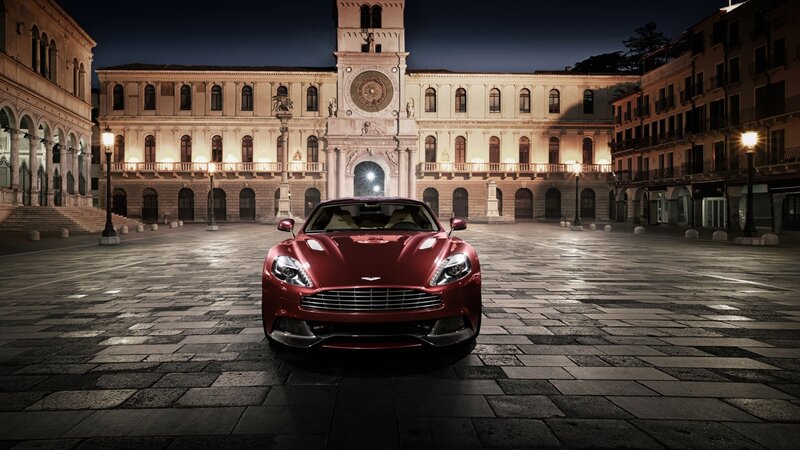 Red Aston Martin in a European square
